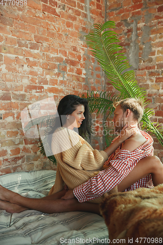 Image of Couple of lovers at home relaxing together, comfortable