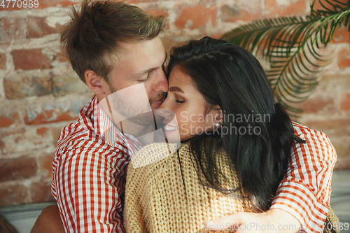 Image of Couple of lovers at home relaxing together, comfortable