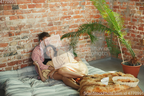Image of Couple of lovers at home relaxing together, comfortable