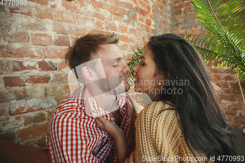 Image of Couple of lovers at home relaxing together, comfortable