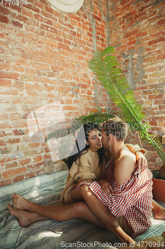 Image of Couple of lovers at home relaxing together, comfortable