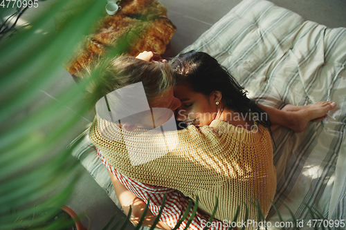 Image of Couple of lovers at home relaxing together, comfortable