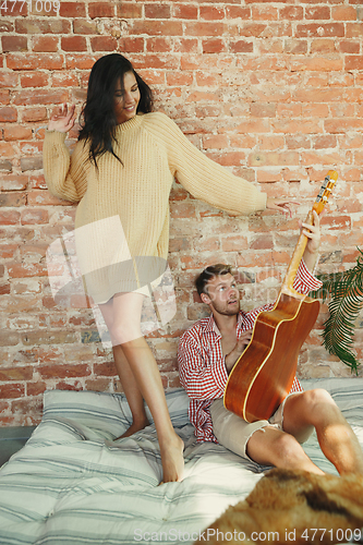 Image of Couple of lovers at home relaxing together, comfortable