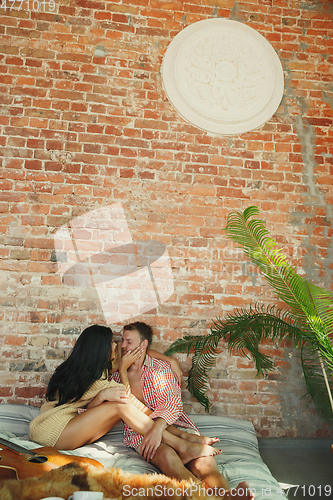 Image of Couple of lovers at home relaxing together, comfortable