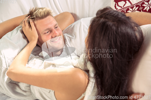 Image of Couple of lovers at home relaxing together, comfortable