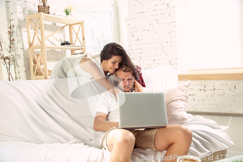 Image of Couple of lovers at home relaxing together, comfortable