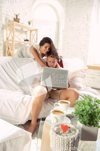 Image of Couple of lovers at home relaxing together, comfortable