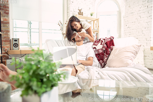Image of Couple of lovers at home relaxing together, comfortable