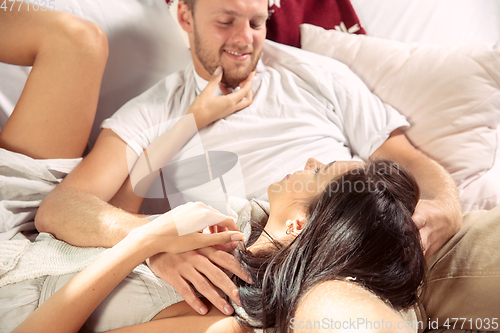 Image of Couple of lovers at home relaxing together, comfortable