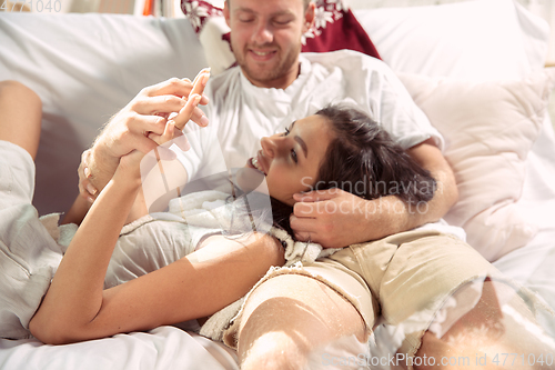 Image of Couple of lovers at home relaxing together, comfortable