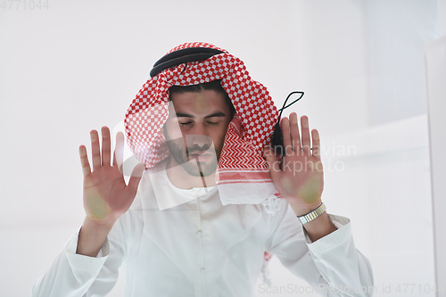 Image of Muslim man doing sujud or sajdah on the glass floor