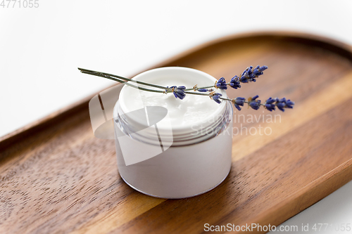 Image of close up of lavender moisturizer on wooden tray