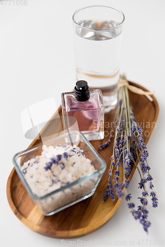 Image of sea salt, perfume and lavender on wooden tray