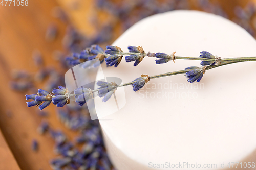 Image of close up of crafted lavender soap on wooden tray