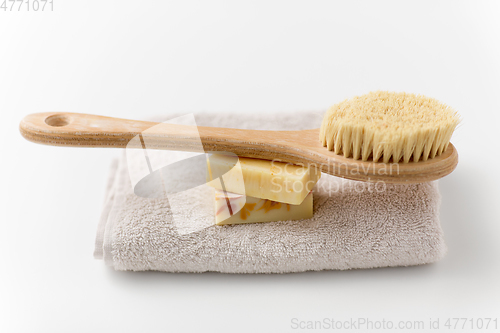 Image of crafted soap bars, natural brush and bath towel