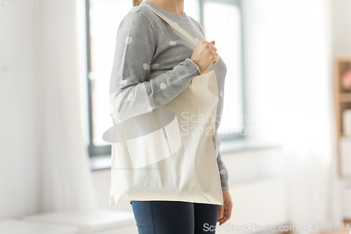 Image of woman with reusable canvas bag for food shopping