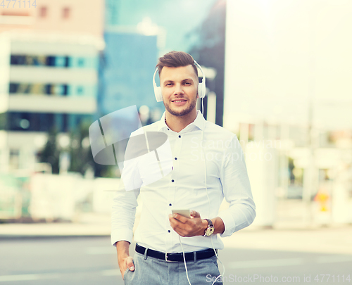 Image of man with headphones and smartphone listening music