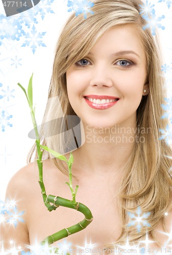 Image of blue-eyed blonde with bamboo