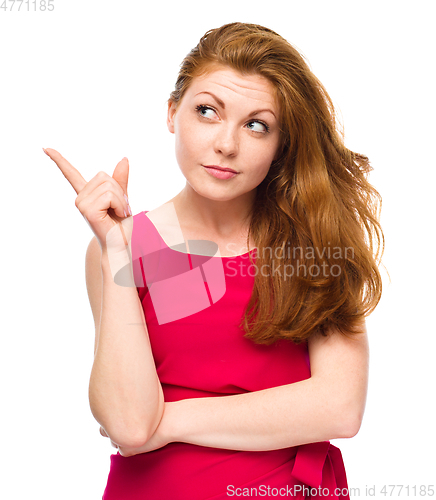 Image of Portrait of a young woman pointing to the left