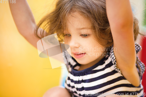 Image of Cute little girl is playing in playground