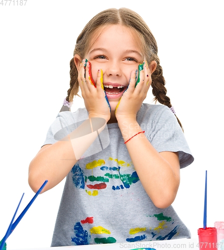 Image of Little girl is holding her face in astonishment