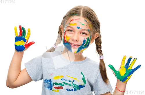 Image of Portrait of a cute girl playing with paints