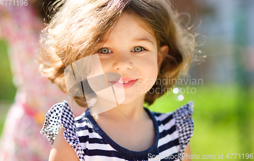 Image of Cute little girl is playing in playground