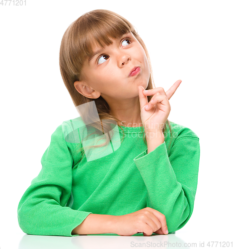 Image of Portrait of a young girl pointing to the right
