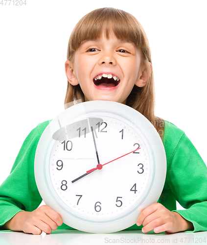 Image of Little girl is holding big clock