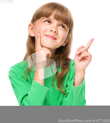 Image of Portrait of a young girl pointing up
