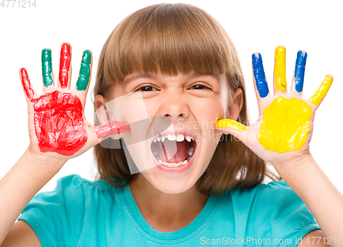 Image of Portrait of a cute girl playing with paints