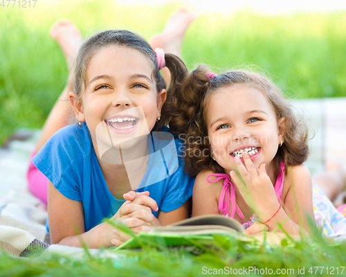 Image of Two little girls are reading book