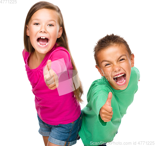 Image of Little boy and girl are showing thumb up sign