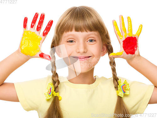 Image of Portrait of a cute girl playing with paints