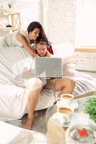 Image of Couple of lovers at home relaxing together, comfortable