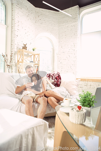 Image of Couple of lovers at home relaxing together, comfortable