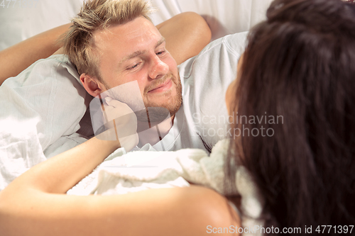 Image of Couple of lovers at home relaxing together, comfortable