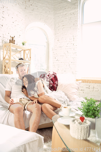 Image of Couple of lovers at home relaxing together, comfortable