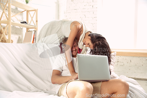 Image of Couple of lovers at home relaxing together, comfortable