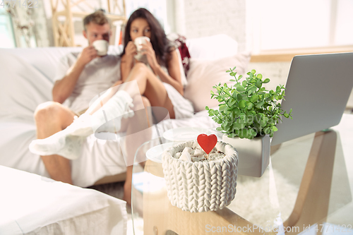 Image of Couple of lovers at home relaxing together, comfortable