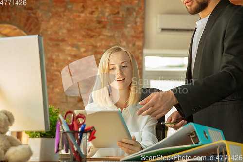 Image of A young businesswoman moving in office, getting new work place