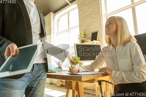 Image of A young businesswoman moving in office, getting new work place