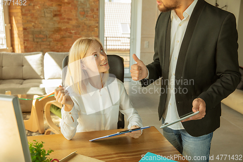 Image of A young businesswoman moving in office, getting new work place