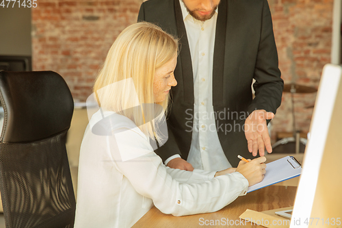 Image of A young businesswoman moving in office, getting new work place