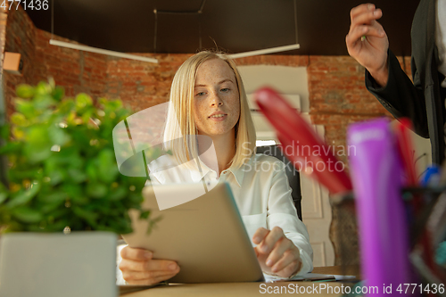 Image of A young businesswoman moving in office, getting new work place