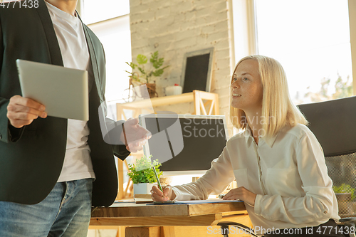 Image of A young businesswoman moving in office, getting new work place