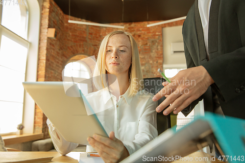 Image of A young businesswoman moving in office, getting new work place