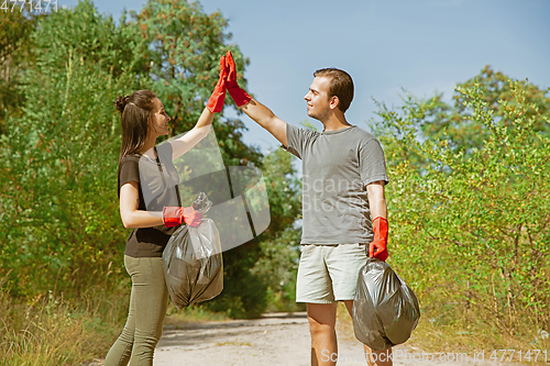 Image of Group of volunteers tidying up rubbish on beach