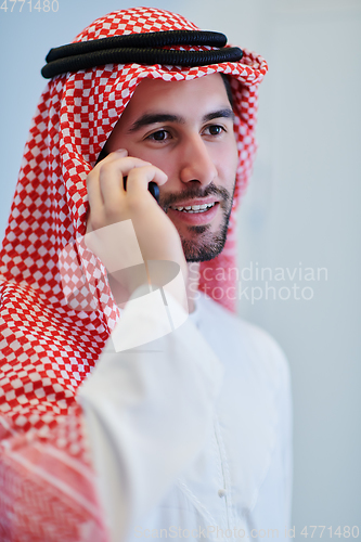 Image of Portrait of young muslim businessman using mobile phone