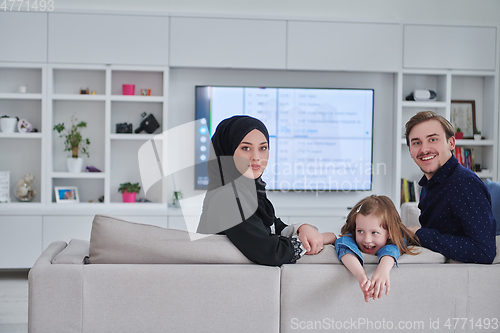 Image of Happy Muslim family spending time together in modern home